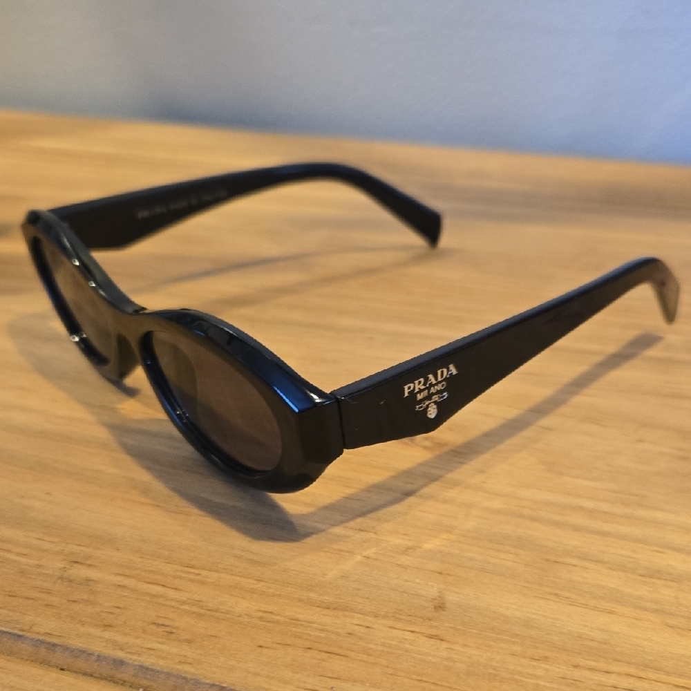 Prada Black Oval Sunglasses with Glossy Finish
